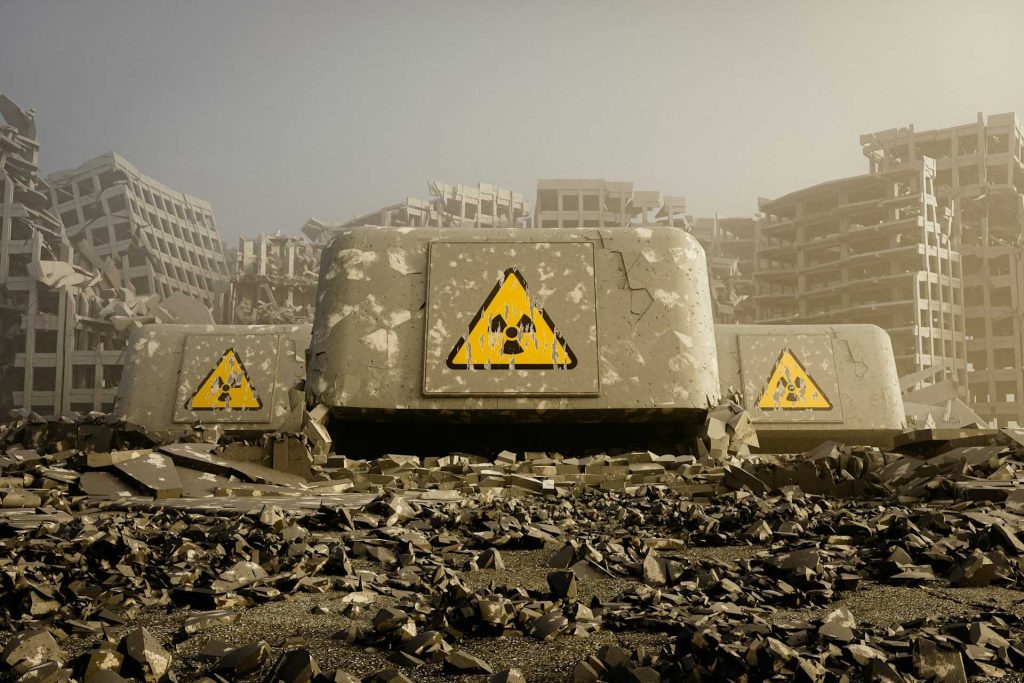 A desolate, ruined cityscape features crumbling buildings and large concrete barriers marked with radiation warning signs.